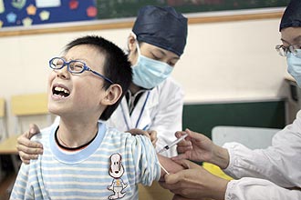 Criana recebe vacina contra gripe suna em uma escola em Shanghai; pas fechou empresa que vendia falsas mscaras 