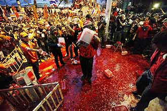 Camisas-vermelhas jogam prprio sangue nos portes da sede do governo da Tailndia defendendo um "sacrifcio pela democracia"