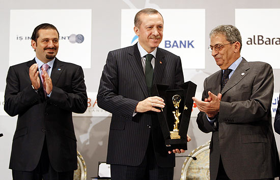 Premiê turco (centro) recebe placa do chefe da Liga Árabe (dir.) e do premiê libanês durante encontro na Turquia