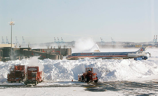 Mquinas removem neve da pista no Aeroporto Internacional de Newark; mais de 2.000 voos foram afetados