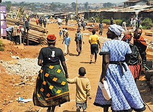 Mulher leva seu neto da escola para casa em Kibera, maior favela da frica, localizada em Nairbi, capital do Qunia