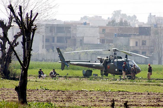 Soldados paquistaneses guardam local onde helicptero fez pouso no programado em Islamabad, no Paquisto