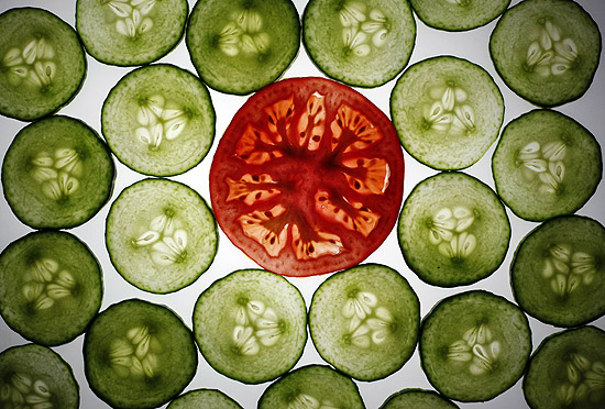 ORG XMIT: BER800 Slices of cucumber and a tomato slice are pictured in this illustration photo taken in Berlin May 30, 2011. A German hospital said on Monday it anticipates the deadly E. coli outbreak will worsen in the coming week as a virulent strain of the bacteria has so far killed 11 people and left more than 300 seriously ill, mostly in northern Germany. The outbreak of E. coli-caused hemolytic-uremic syndrome (HUS), a serious complication of a type of E. coli known as Shiga toxin-producing E. Coli (STEC) is the largest ever of its kind in Germany and worldwide, the European Centre for Disease Prevention and Control (ECDC) said in a risk assessment. German authorities have warned consumers to avoid eating raw cucumbers, lettuces and tomatoes and has removed some products from store shelves. REUTERS/Pawel Kopczynski (GERMANY - Tags: AGRICULTURE FOOD HEALTH IMAGES OF THE DAY)