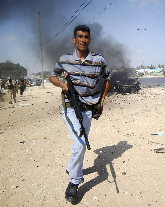 Rebelde líbio em confronto com as forças de Gaddafi na floresta Gadayem, a oeste da capital Trípoli