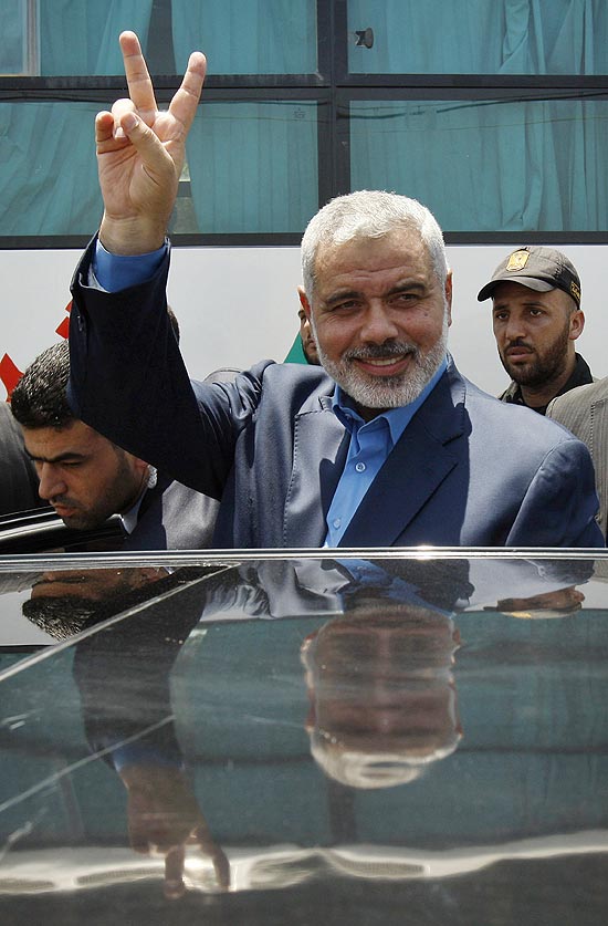 O lder do Hamas, Ismail Haniyeh, faz sinal de vitria antes de viajar ao Egito, onde encontrar o presidente Mursi