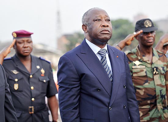 ORG XMIT: SK016 (FILES) In this photo taken on February 4, 2011 Ivory Coast strongman Laurent Gbagbo (C) attends in Abidjan a ceremony to pay tribute to thirty-two members of the National Armed Forces of Ivory Coast (FANCI) that lost their lives during the post-electoral violence, spawned by the November 28, 2010 presidential elections.Rival's forces entered Ivory Coast strongman Laurent Gbagbo residence compound in Abidjan on April 11, 2011. AFP PHOTO/ SIA KAMBOU
