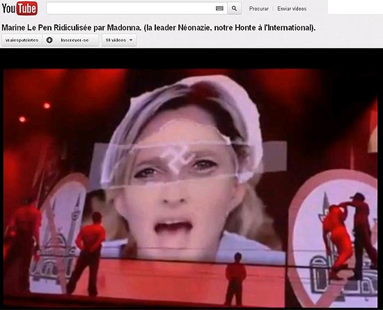 Reprodução de vídeo do YouTube que mostra momento do show em que Le Pen aparece com suástica na testa