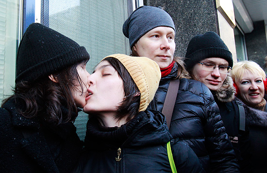 ORG XMIT: MOS10 Women share a kiss during a protest near the Duma, Russia