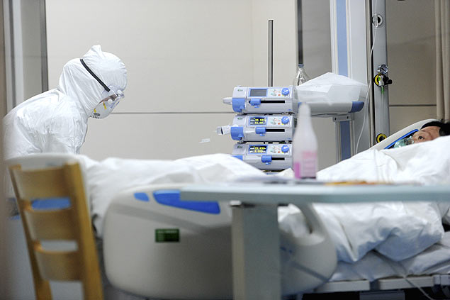 Mdico com proteo qumica toma conta de paciente de 55 anos infectado pelo vrus H7N9 em hospital de Anhui, na China