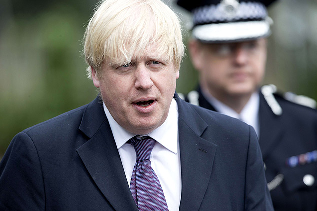 Boris Johnson, prefeito de Londres, anda em frente de policial