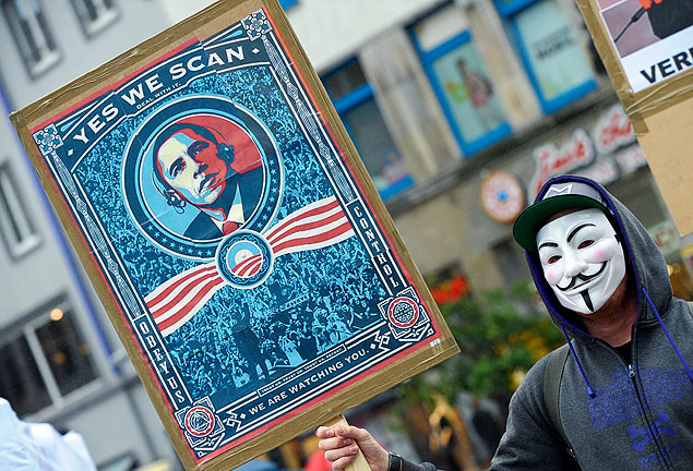 In this picture, taken Saturday June 29, 2013, a demonstrator protests with a poster against NSA in Hanover, Germany. Germany's top justice official says reports that U.S. intelligence bugged European Union offices remind her of 