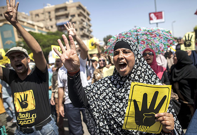 Apoiantes do presidente egpcio deposto Mohamed Morsi levantam cartazes com o smbolo de quatro dedos durante uma manifestao contra o governo militar na capital egpcia Cairo, em 13 de setembro