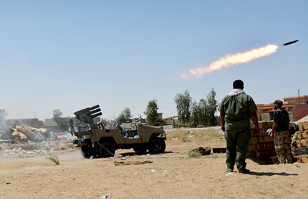 Milicianos xiitas lanam foguetes contra reas dominadas pelo Estado Islmico em Baji, no Iraque