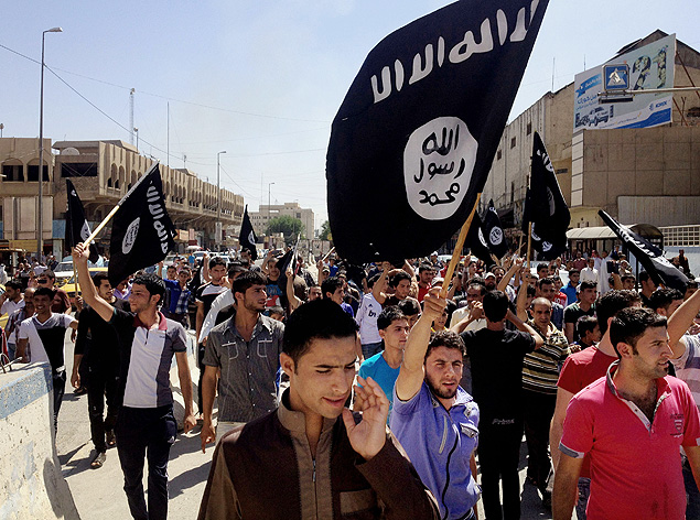 FILE - In this Monday, June 16, 2014 file photo, demonstrators chant pro-Islamic State group slogans as they wave the group's flags in front of the provincial government headquarters in Mosul, 225 miles (360 kilometers) northwest of Baghdad, Iraq. (AP Photo/File) ORG XMIT: NY622