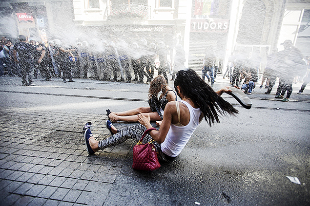 Manifestantes so atingidas por canho de gua da polcia durante marcha do orgulho gay em Istambul