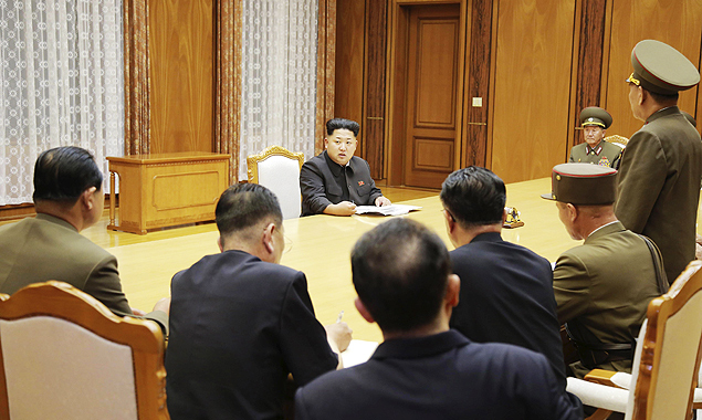 North Korean leader Kim Jong Un (back C) speaks at an emergency meeting of the Workers' Party of Korea (WPK) Central Military Commission, in this undated photo released by North Korea's Korean Central News Agency (KCNA) in Pyongyang on August 21, 2015. North Korean leader Kim Jong Un ordered his troops onto a war footing from 5 p.m on Friday after Pyongyang issued an ultimatum to Seoul to halt anti-North propaganda broadcasts by Saturday afternoon or face military action. REUTERS/KCNA ATTENTION EDITORS - THIS PICTURE WAS PROVIDED BY A THIRD PARTY. REUTERS IS UNABLE TO INDEPENDENTLY VERIFY THE AUTHENTICITY, CONTENT, LOCATION OR DATE OF THIS IMAGE. NO THIRD PARTY SALES. NOT FOR USE BY REUTERS THIRD PARTY DISTRIBUTORS. FOR EDITORIAL USE ONLY. NOT FOR SALE FOR MARKETING OR ADVERTISING CAMPAIGNS. SOUTH KOREA OUT. NO COMMERCIAL OR EDITORIAL SALES IN SOUTH KOREA. THIS PICTURE IS DISTRIBUTED EXACTLY AS RECEIVED BY REUTERS, AS A SERVICE TO CLIENTS. ORG XMIT: SIN801
