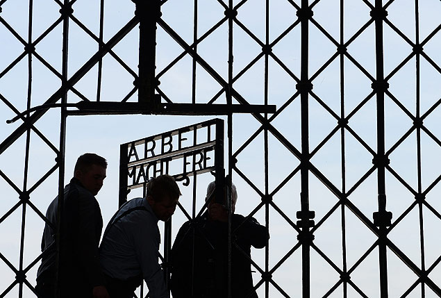Workers fix the new entrance gate door with the inscription 'Work sets you free' (Arbeit macht frei) of former concentration camp in Dachau, southern Germany, on April 29, 2015. The old entrance gate had been stolen on November 2, 2014. Dachau was opened in 1933, less than two months after Adolf Hitler became German chancellor, to house political prisoners. More than 200,000 Jews, gays, Roma, political opponents, disabled people and prisoners of war were imprisoned at the camp. Over 41,000 people were killed, starved or died of disease before the US troops liberated it. AFP PHOTO / CHRISTOF STACHE ORG XMIT: CST005
