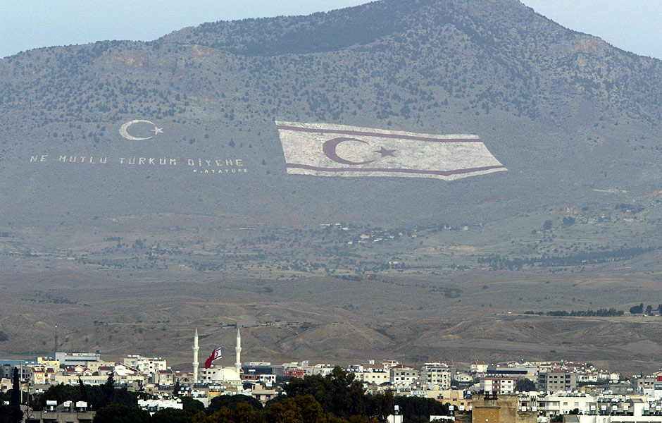 ORG XMIT: 383301_1.tif A giant Turkish Cypriot flag is seen painted on the side of the Besparmak mountains from the northern part of the divided capital Nicosia, 13 December 2003. Cypriot Turks and Turkish mainland settlers go to parliamentary polls 14th of December in crucial elections in the self-styled Turkish Republic of Northern Cyprus (TRNC) which could oust Turkish Cypriot leader Rauf Denktash and lead to reunification of the divided island under a UN plan Denktash opposes. AFP PHOTO / TARIK TINAZAY 