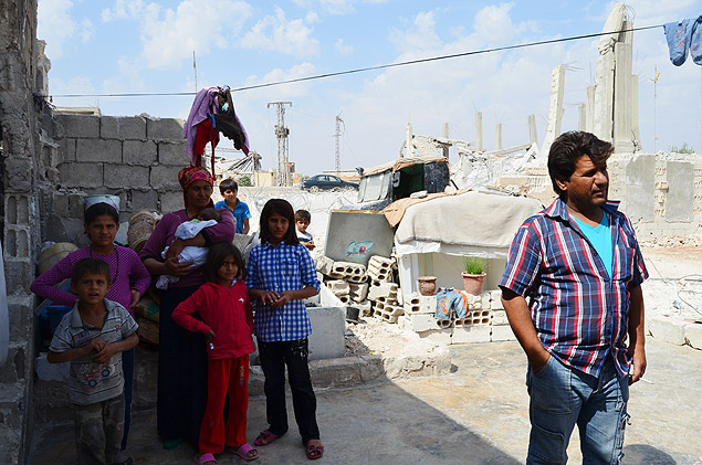 Famlia que teve a casa destruda em Kobani, no norte da Sria, hoje vive em runas