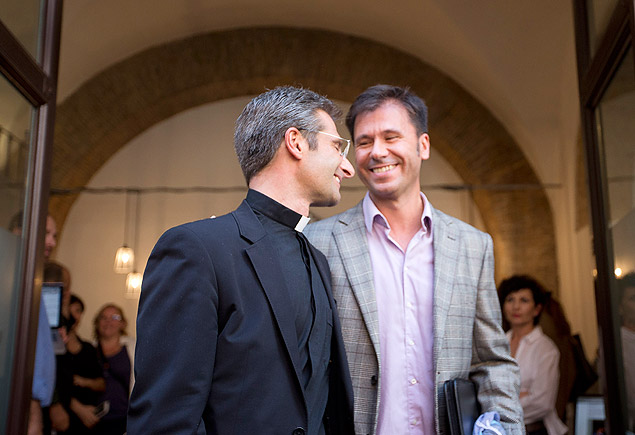Monsignor Krzysztof Charamsa, left, and his partner Eduard, surname not given, leave a restaurant after a press conference in downtown Rome, Saturday Oct. 3, 2015. The Vatican on Saturday fired Charamsa who came out as gay on the eve of a big meeting of the world's bishops to discuss church outreach to gays, divorcees and more traditional Catholic families. (AP Photo/Alessandra Tarantino) ORG XMIT: ALT106