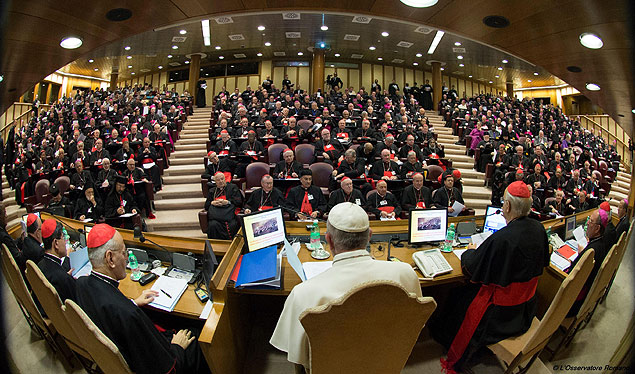 In this handout picture released by the Vatican press office, Pope Francis (C) attends the Synod on the family on October 5, 2015, as cardinals and bishops gather in the Synod Aula, at the St Peter's basilica in Vatican. Pope Francis on October 4 defended marriage and heterosexual couples as he opened a synod on the family overshadowed by a challenge to Vatican orthodoxy by a gay priest. AFP PHOTO / OSSERVATORE ROMANO RESTRICTED TO EDITORIAL USE - MANDATORY CREDIT 