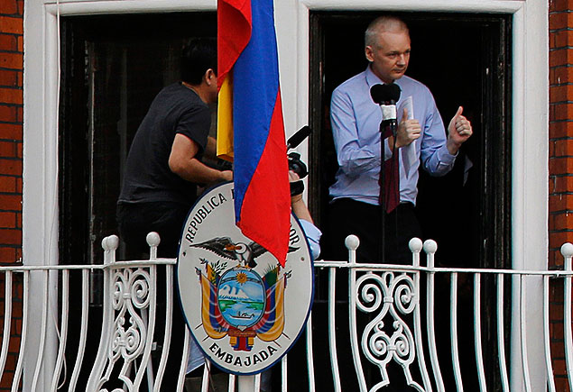 Wikileaks founder Julian Assange gestures as he speaks from the balcony of Ecuador's embassy, where he is taking refuge as a police officer stands guard beneath, in London in this file picture taken August 19, 2012. The Metropolitan Police have announced they are withdrawing their round the clock guard of the embassy. REUTERS/Chris Helgren ORG XMIT: LON900