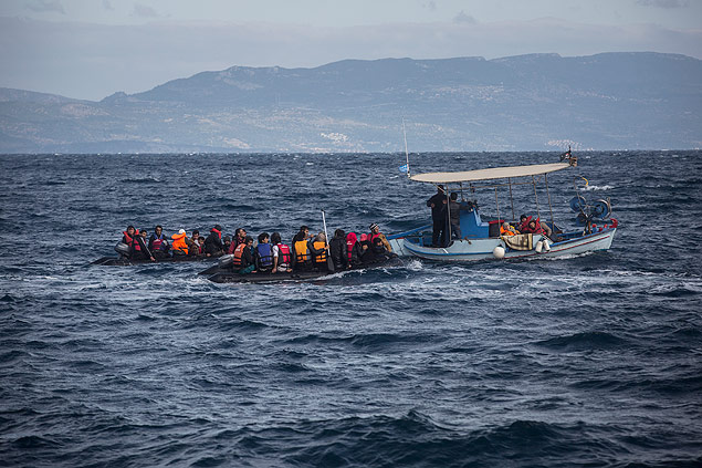 Two dinghies carrying migrants and refugees from nearby Turkey are tugged to safety by a local fishing boat near the village of Skala, on the Greek island of Lesbos, on Sunday, Nov. 1, 2015. Authorities recovered more bodies on Lesbos and the Greek island of Samos Sunday as thousands continue to cross from the nearby coast of Turkey despite worsening weather. Greece is pressing the European Union for additional support for their massive daily search and rescue operations. (AP Photo/Santi Palacios) ORG XMIT: XSP107