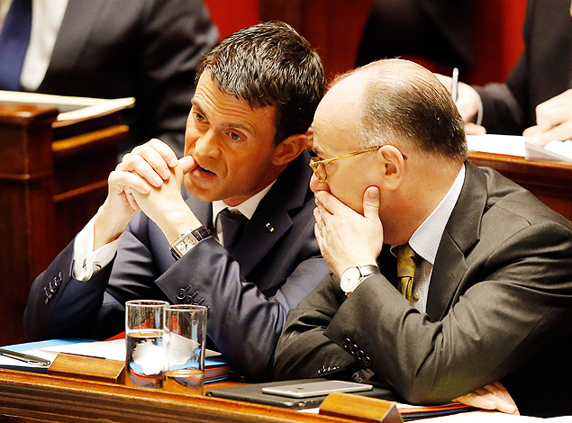 French Prime Minister Manuel Valls, left, listens to French Interior Minister Bernard Cazeneuve at the national assembly in Paris, Thursday Nov.19,2015. Valls is warning that the associates of extremists who targeted France last week could use chemical and biological weapons, as he urged Parliament to extend a state of emergency. (AP Photo/Michel Euler) ORG XMIT: FAS105