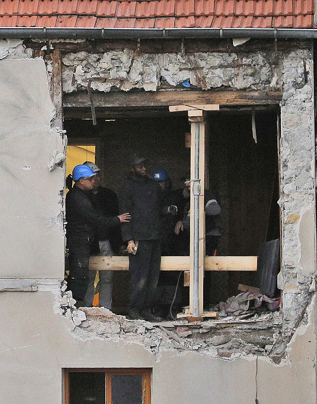 People work inside the damaged building of Wednesday's raid on an apartment in the Paris suburb of Saint-Denis, Thursday Nov.19, 2015. Abdelhamid Abaaoud, the Belgian extremist suspected of masterminding the deadly attacks in Paris died a day ago along with his female cousin in a police raid on a suburban apartment building.(AP Photo/Christophe Ena) ORG XMIT: FAS121