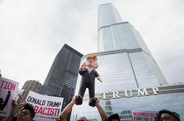 OCTOBER 12: Demonstrators hold up a piñata of Republican Presidential candidate Donald Trump during a protest outside Trump Tower on October 12, 2015 in Chicago, Illinois. About 250 demonstrators marched through downtown before holding a rally calling for immigration reform and fair wages in front of Trump Tower. Trump has been an outspoken proponent of a plan to deport undocumented immigrants. Scott Olson/Getty Images/AFP == FOR NEWSPAPERS, INTERNET, TELCOS & TELEVISION USE ONLY == 