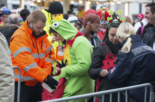  04/02/2016.- Varios agentes revisan las mochilas de varios participantes del carnaval en Maguncia (Alemania) hoy, 4 de febrero de 2016. Las autoridades han reforzado las medidas de seguridad durante el carnaval tras los ataques a mujeres perpetrados en Nochevieja. EFE/Frank Rumpenhorst ORG XMIT: koe124