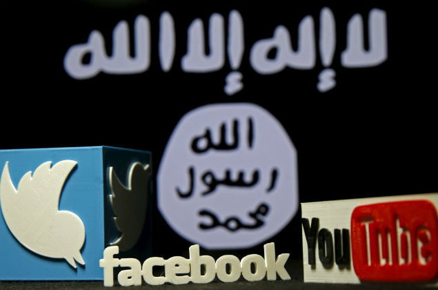 3D plastic representation of the Twitter and Youtube logo is seen in front of a displayed ISIS flag in this photo illustration in Zenica, Bosnia and Herzegovina, February 3, 2016. Iraq is trying to persuade satellite firms to halt Internet services in areas under Islamic State's rule, seeking to deal a major blow to the group's potent propaganda machine which relies heavily on social media to inspire its followers to wage jihad. Picture taken February 3, 2016. To match Insight MIDEAST-CRISIS/IRAQ-INTERNET REUTERS/Dado Ruvic TPX IMAGES OF THE DAY ORG XMIT: DAD02