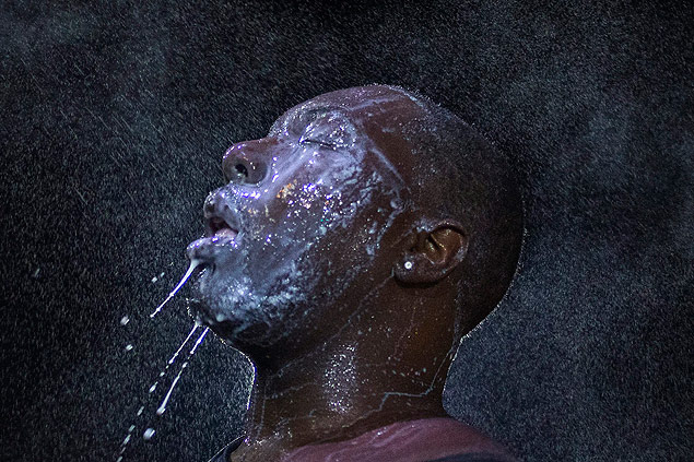 A man is doused with milk and sprayed with mist after being hit by an eye irritant from security forces trying to disperse demonstrators protesting against the shooting of unarmed black teen Michael Brown in Ferguson, Missouri, in this August 20, 2014 file photo. The U.S. Justice Department said on February 10, 2016 that it had filed a civil rights lawsuit against Ferguson, Missouri, to enforce a police and court reform plan after the city said it wanted to amend some aspects of a consent decree it reached with the federal agency. REUTERS/Adrees Latif/Files ORG XMIT: WAS103
