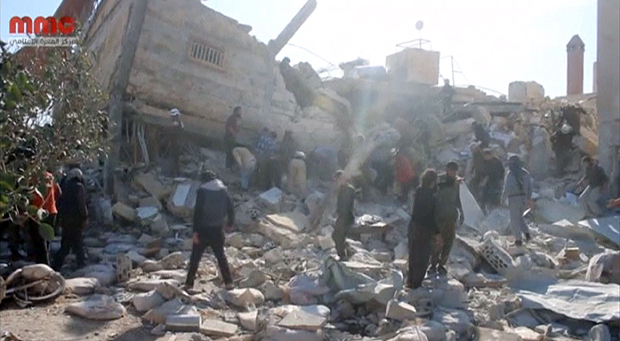 People gather near a destroyed building said to be a Medecins Sans Frontieres (MSF) supported hospital in Marat al Numan, Idlib, Syria, February 15, 2016 in this still image taken from a video on a social media website. French charity Doctors Without Borders/Medecins Sans Frontieres (MSF) said in a statement that at least eight staff were missing after four rockets hit a hospital that it supported in the province of Idlib in north western Syria. REUTERS/Social Media Website via Reuters TVATTENTION EDITORS - THIS PICTURE WAS PROVIDED BY A THIRD PARTY. REUTERS IS UNABLE TO INDEPENDENTLY VERIFY THE AUTHENTICITY, CONTENT, LOCATION OR DATE OF THIS IMAGE. EDITORIAL USE ONLY. NOT FOR SALE FOR MARKETING OR ADVERTISING CAMPAIGNS. NO RESALES. NO ARCHIVE. THIS PICTURE IS DISTRIBUTED EXACTLY AS RECEIVED BY REUTERS, AS A SERVICE TO CLIENTS TPX IMAGES OF THE DAY ORG XMIT: SIN500