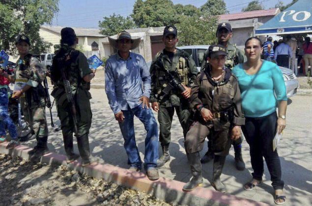 RC leftist guerrillas pose for a photo in the village of El Conejo, La Guajira, Colombia, on February 18, 2016, during a public event in which participated FARC commanders Ivan Marquez, Jesus Santrich and Joaquin Gomez participated.