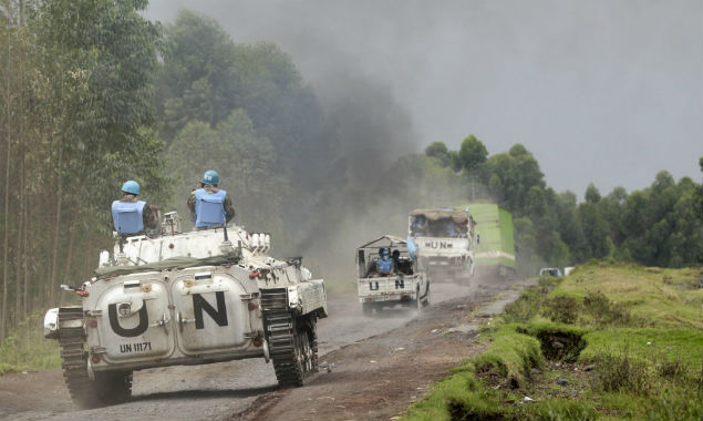 U.N. peacekeepers drive their tank as they patrol past the deserted Kibati village near Goma in the eastern Democratic Republic of Congo, August 7, 2013. A 17,000-strong U.N. force, known as MONUSCO, and Congo troops have struggled over the past decade to stem a conflict involving dozens of armed groups and complicated by national and ethnic rivalries. A new 3,000-member U.N. Intervention Brigade was recently deployed to fight and disarm rebels in the east. REUTERS/Thomas Mukoya (DEMOCRATIC REPUBLIC OF CONGO - Tags: SOCIETY CIVIL UNREST MILITARY POLITICS) ORG XMIT: AFR515