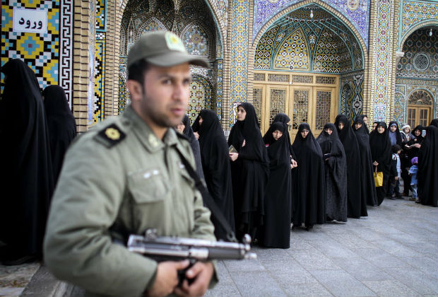  A soldier stands guard at a polling station in the city of Qom, Iran, on Feb. 26, 2016. Large numbers of voters lined up in long queues in front of the polling stations in Iran's major cities since early Friday morning to cast their ballots in two key elections. The elections for Iran's Parliament (Majlis) and Assembly of Experts started at 8 a.m. local time. (Xinhua/Ahmad Halabisaz)