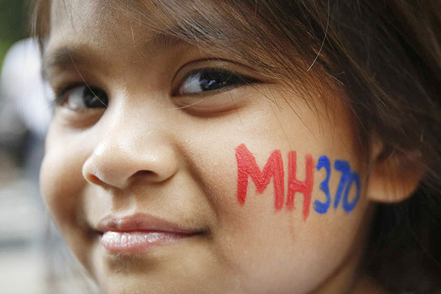 A Malaysian child has her face painted with MH370 during a remembrance event for the ill fated Malaysia Airlines Flight 370 in Kuala Lumpur, Malaysia, Sunday, March 6, 2016. At the commemorative event Sunday to mark the second anniversary of the jet’s March 8, 2014, disappearance, the families of Flight 370 passengers released white balloons tagged with the names of everyone aboard the plane and the words: “MH370: Always remembered in our hearts.” (AP Photo/Joshua Paul) ORG XMIT: XJP104