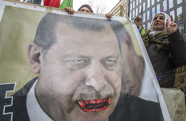 Manifestantes curdos levam cartaz do presidente Recep Tayyip Erdogan em protesto em Bruxelas