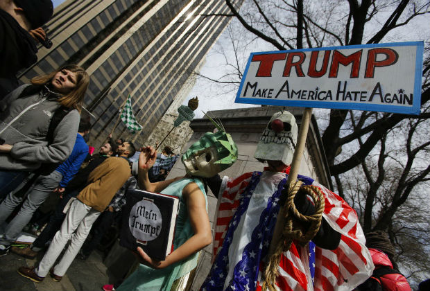  People take part in a protest against Republican presidential candidate Donald Trump, on March 19, 2016 in New York City. People protest against Trump's policies which threaten the Immigration system and many of the Latino, Black, LGBT, Muslim, and other communities. Eduardo Munoz Alvarez/Getty Images/AFP == FOR NEWSPAPERS, INTERNET, TELCOS & TELEVISION USE ONLY ==