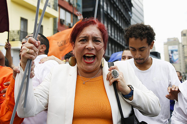 Tamara Adrian shouts as she arrives to register her candidacy for the upcoming parliamentary elections at an office of the National Electoral Council (CNE) in Caracas August 7, 2015. The first transgender politician to run for popular election in Venezuela on Friday registered as candidate for Congress as part of the opposition bloc, promising to advance gay rights in the traditionally macho South American society. Lawyer and gay rights activist Adrian aims to register as a woman, though she had to register under her given name Thomas Adrian despite a 2002 sex change and it remains unclear if electoral authorities will categorize her as a woman. REUTERS/Carlos Garcia Rawlins ORG XMIT: VEN04