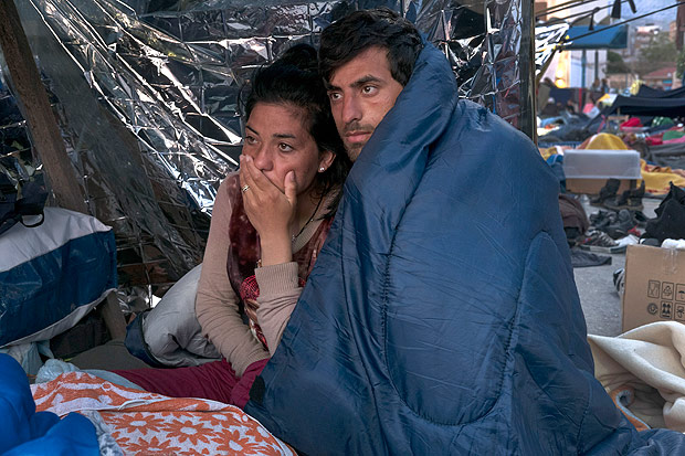 Migrants who are stranded along the Greek port of Chios wait to learn their fate, April 5, 2016. More than 52,000 migrants are trapped in Greece after Balkan countries shut their borders. Under a deal that took effect last month, all migrants who arrived in Greece after March 20 are to be deported to Turkey. (Tyler Hicks/The New York Times)