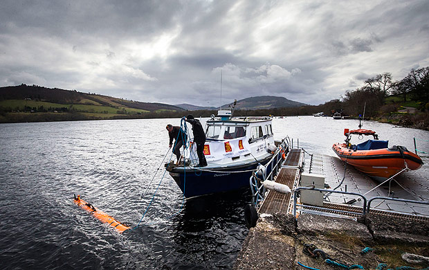 In this picture taken April 13, 2016, engineer John Haig helps launch the Munin AUV (Autonomous Underwater Vehicle) at Loch Ness. An underwater robot exploring Loch Ness has discovered a dark, monster-shaped mass in its depths. Disappointingly, tourism officials say the 30-foot (9 meter), object is not the fabled Loch Ness Monster, but a prop left over from a 1970 film. (Danny Lawson/PA via AP) UNITED KINGDOM OUT NO SALES NO ARCHIVE ORG XMIT: LON817