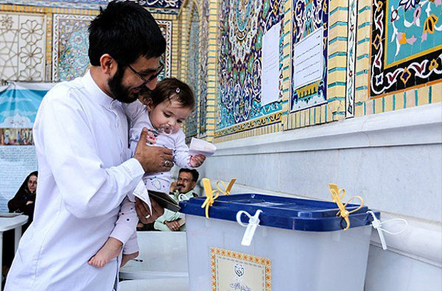 An Iranian man holds a girl as he casts his vote during a second round of parliamentary elections, in Shiraz, Iran April 29, 2016. Farsnews.com/Handout via REUTERS ATTENTION EDITORS - THIS IMAGE WAS PROVIDED BY A THIRD PARTY. REUTERS IS UNABLE TO INDEPENDENTLY VERIFY THE AUTHENTICITY, CONTENT, LOCATION OR DATE OF THIS IMAGE. EDITORIAL USE ONLY. NO RESALES. NO ARCHIVE. ORG XMIT: GAZ02