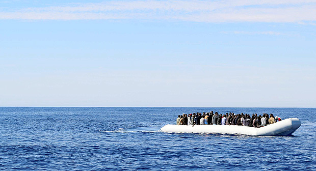 Migrants sit in their boat during a rescue operation by Italian navy ship Grecale (unseen) off the coast of Sicily, Italy, in this handout picture courtesy of the Italian Marina Militare released on May 6 2016. Marina Militare/Handout via REUTERS ATTENTION EDITORS - THIS PICTURE WAS PROVIDED BY A THIRD PARTY. FOR EDITORIAL USE ONLY. ORG XMIT: SRE101