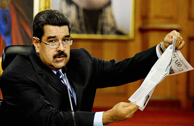 Venezuelan President Nicolas Maduro reads a newspaper article during a press conference at the Miraflores presidential palace in Caracas on May 17, 2016. The army in crisis-hit Venezuela has to choose whether it is "with the constitution or with (President Nicolas) Maduro," opposition leader Henrique Capriles said Tuesday. / AFP PHOTO / FEDERICO PARRA ORG XMIT: FPZ1484