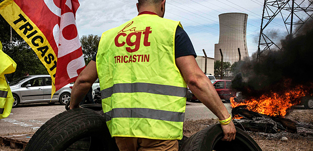 Workers of the Tricastin nuclear power plant protest at the entrance of the site on May 26, 2016 in Saint-Paul-Trois-Chateaux, during a protest against controversial labour market reforms that has already severely disrupted fuel supplies. With two weeks until France hosts the Euro 2016 football championships, the country has been paralysed by a series of transport strikes and fuel shortages that has heaped pressure on the deeply unpopular Socialist government. / AFP PHOTO / JEFF PACHOUD