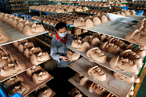 A worker checks a mask of U.S. Republican presidential candidate Donald Trump at Jinhua Partytime Latex Art and Crafts Factory in Jinhua, Zhejiang Province, China, May 25, 2016. There's no masking the facts. One Chinese factory is expecting Donald Trump to beat his likely U.S. presidential rival Hilary Clinton in the popularity stakes. At the Jinhua Partytime Latex Art and Crafts Factory, a Halloween and party supply business that produces thousands of rubber and plastic masks of everyone from Osama Bin Laden to Spiderman, masks of Donald Trump and Democratic frontrunner Hillary Clinton faces are being churned out. Sales of the two expected presidential candidates are at about half a million each but the factory management believes Trump will eventually run out the winner. "Even though the sales are more or less the same, I think in 2016 this mask will completely sell out," said factory manager Jacky Chen, indicating a Trump mask. REUTERS/Aly Song SEARCH "JINHUA MASK" FOR THIS STORY. SEARCH "THE WIDER IMAGE" FOR ALL STORIES. TPX IMAGES OF THE DAY ORG XMIT: PXP11