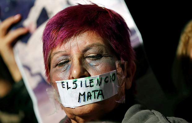 Mulher cobre boca com fita que diz "O Silncio Mata" durante marcha em Buenos Aires, Argentina