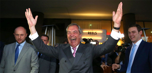 Leader of the United Kingdom Independence Party (UKIP), Nigel Farage (C) reacts outside the Leave.EU referendum party at Millbank Tower in central London on June 24, 2016, as results indicate that it looks likely the UK will leave the European Union (EU). Bookmakers dramatically reversed the odds on Britain leaving the European Union on Friday as early results from a historic referendum pointed to strong support for a Brexit. / AFP PHOTO / GEOFF CADDICK